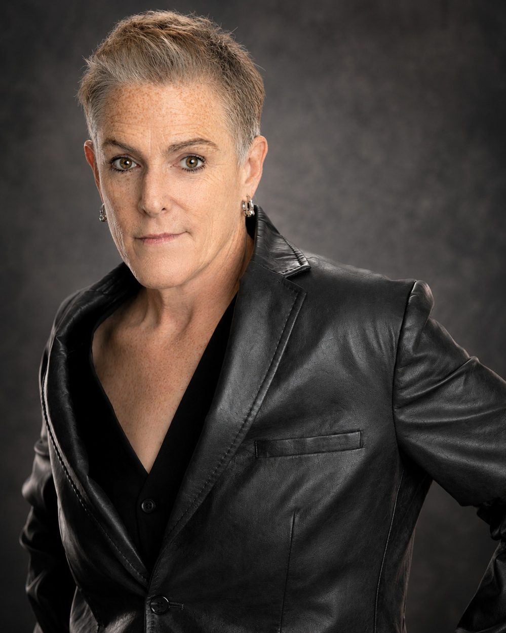 Miller Rae in a black leather jacket against a gray backdrop